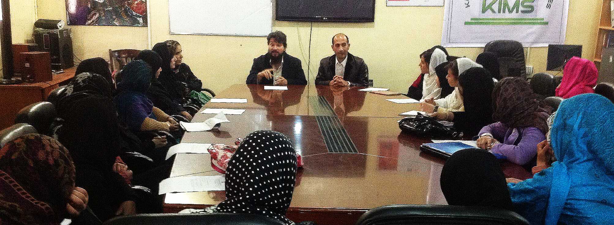 Afghan woman in classroom around table