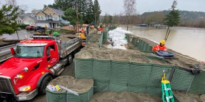 Hesco barrier at river. Truck beside it.