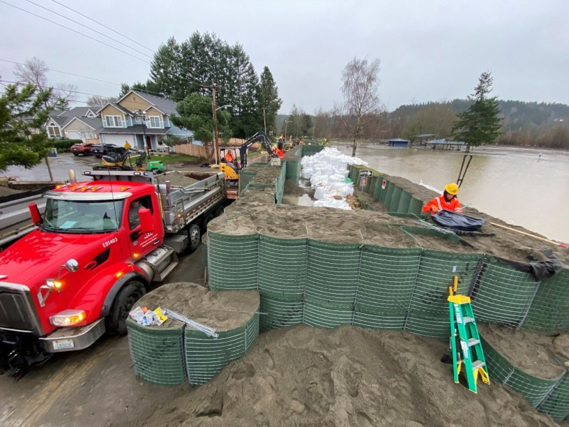 Hesco barrier at river. Truck beside it.