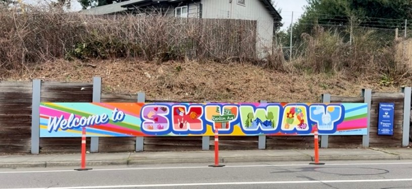 A brightly colored mural with the message "Welcome to Skyway" located along Renton Avenue S.