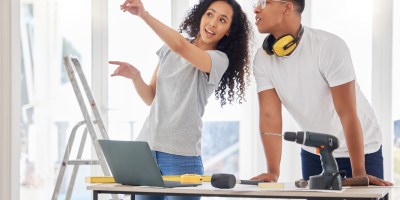 A woman and a man are working on a home improvement project.