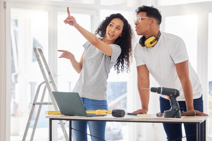 A woman and a man are working on a home improvement project.
