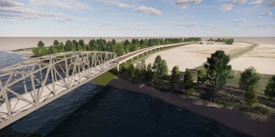 A photo of a bridge over a river with a mostly clear sky in the upper portion of the photo.